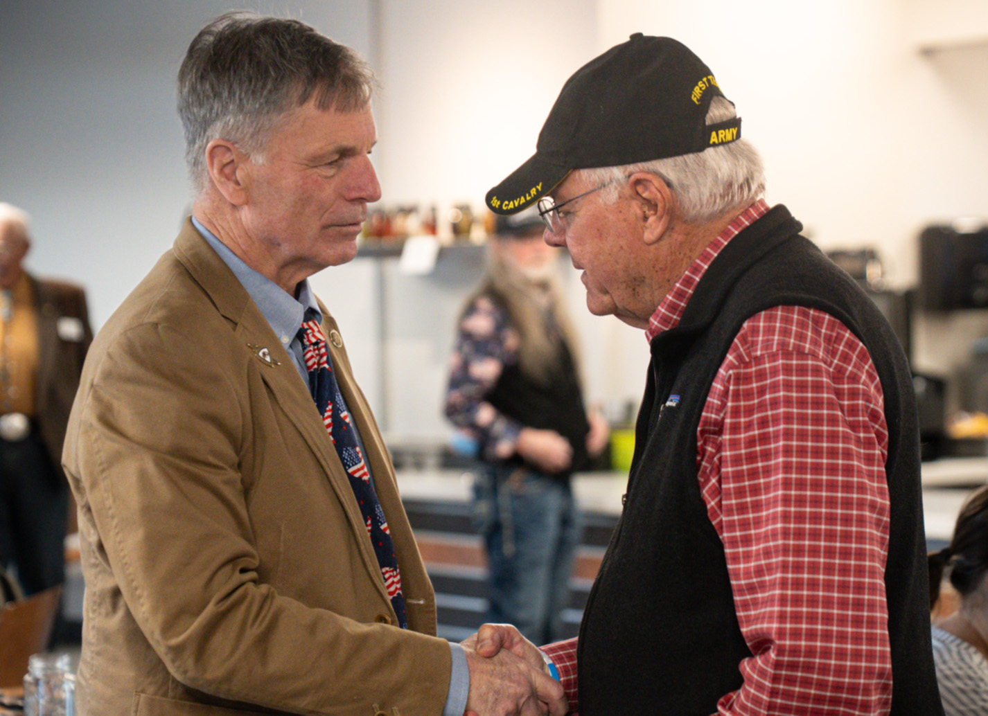 Wyoming Gov. Mark Gordon, left, visits with a Vietnam War veteran during a Vietnam Veterans Day event on March 28, 2026, at the National Museum of Military Vehicles in Dubois, Wyo.