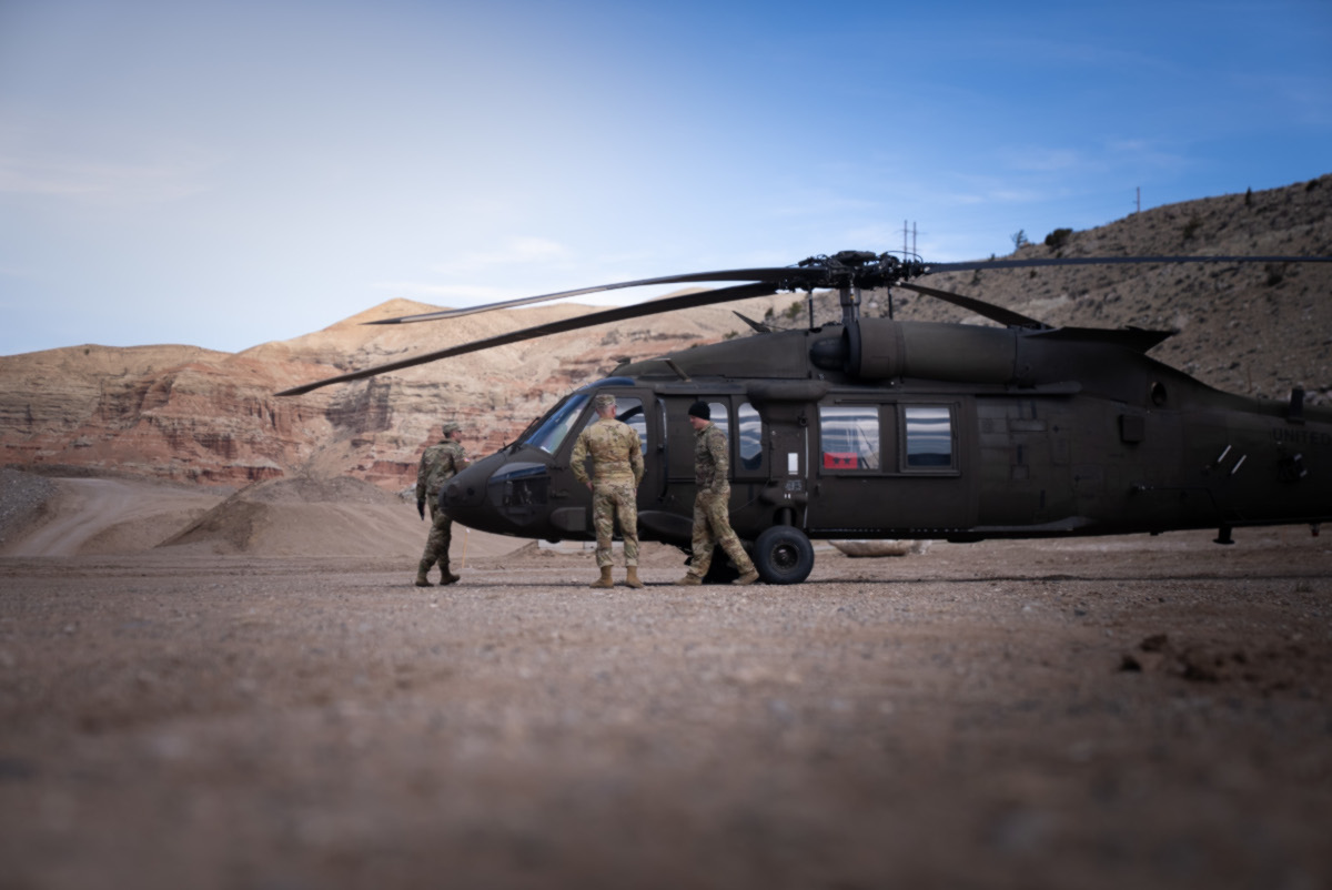 Wyoming National Guard airmen look at a Black Hawk helicopter after landing at the National Museum of Military Vehicles during a Vietnam Veterans Day event on March 28, 2026, in Dubois, Wyo.