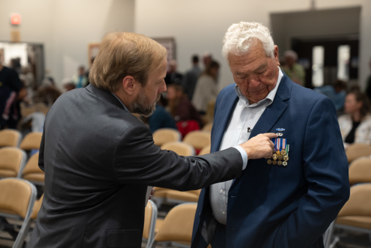 Filmmaker Mat Hames, left, and Lee Alley, Wyoming’s most decorated veteran, share a moment during a Vietnam Veterans Day event on March 28, 2026, at the National Museum of Military Vehicles in Dubois, Wyo.